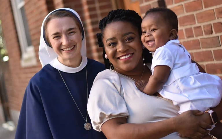 Sisters of life with woman and baby